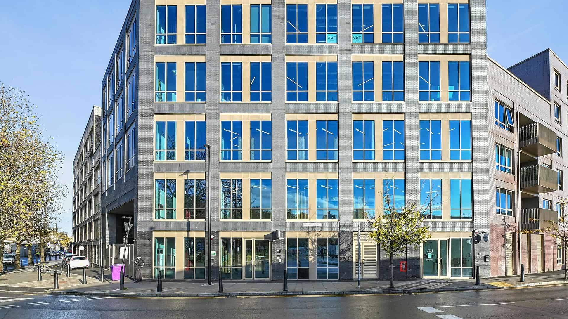 A modern office building located in London with large glass windows, featuring a sleek architectural style, situated near 13 Rothbury Rd E9 5HA.