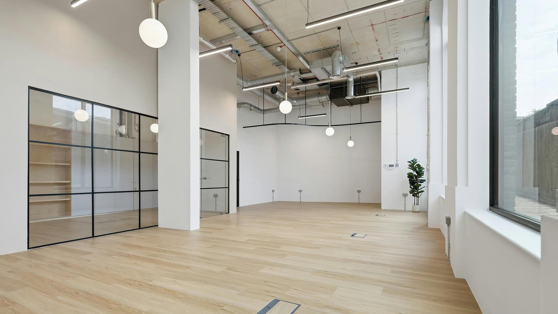 Spacious, modern interior with large windows, wooden flooring, and minimalistic design at Belcor London, Unit 2 Empress Works E2 9FR.