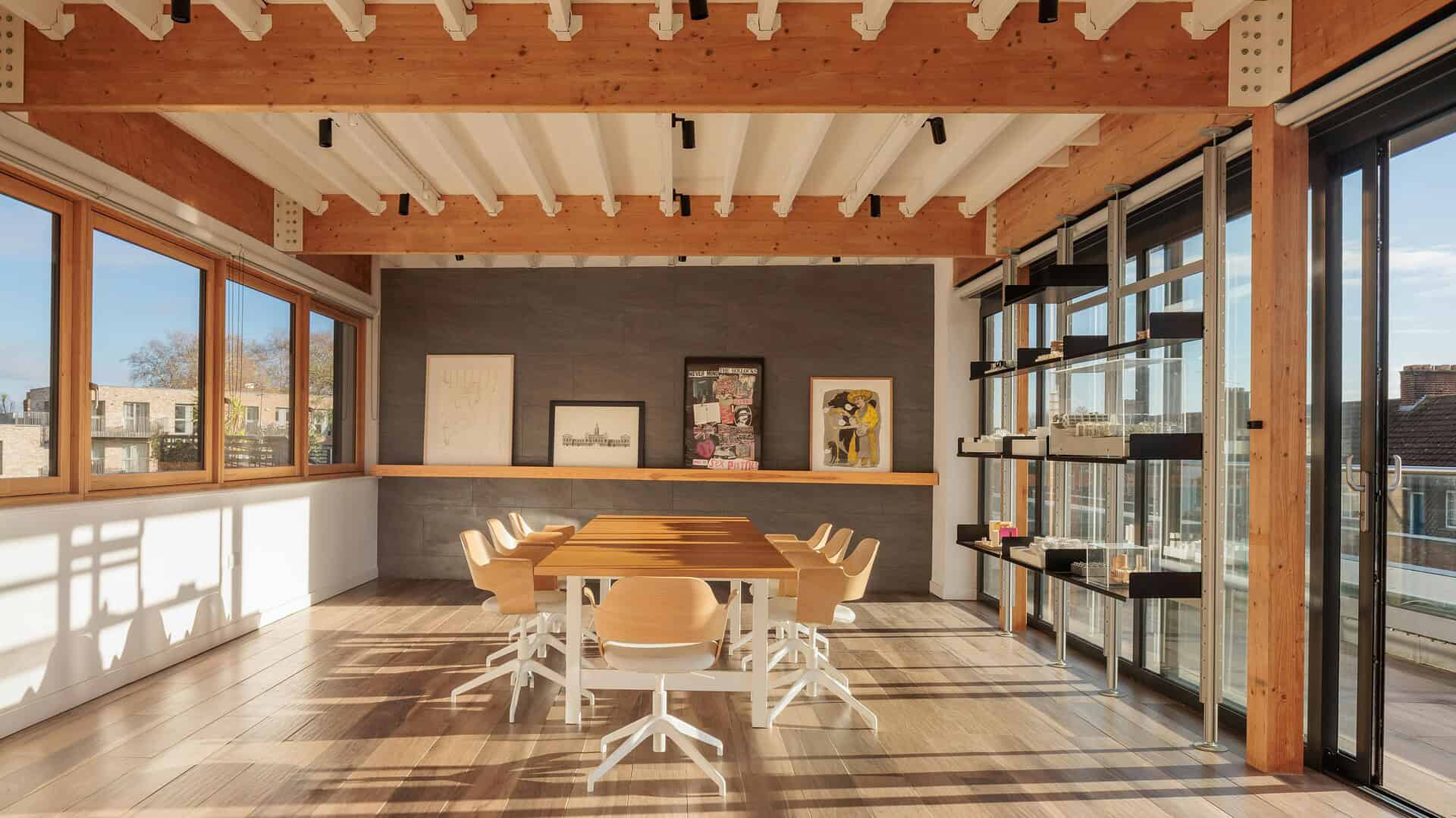 Bright and spacious office meeting room featuring natural light, contemporary furniture, and stylish decor for professional workspace environments.